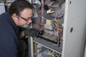 Technician-Looking-Over-Gas-Furnace